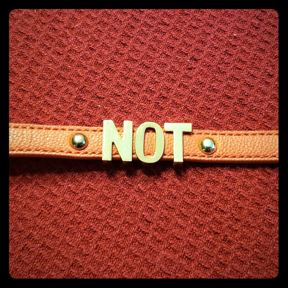 Orange leather band snap on bracelet says NOT